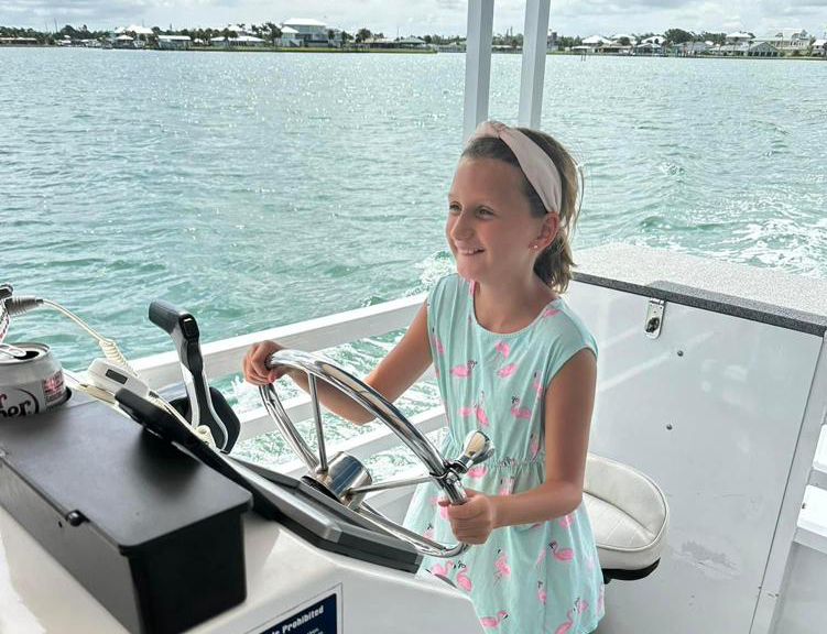 a girl pretending to operate a boat